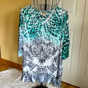 Top with decorative accents. Handkerchief bottom.